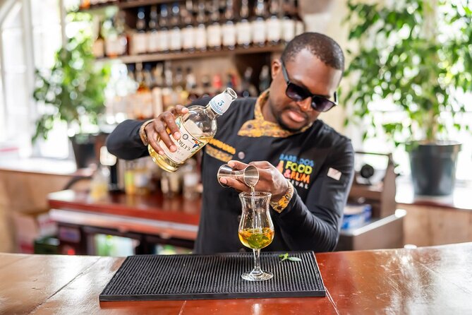 Master local mixologist creating a rum cocktail
